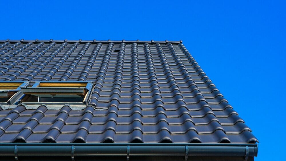 commercial roofing is used in the tiled roof with a blue sky background