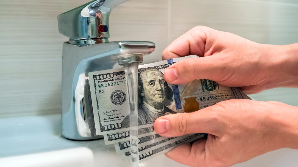 plumber cleaning money using water