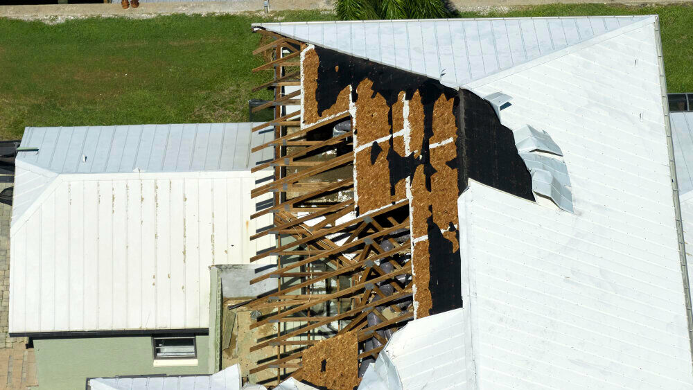 housing with a damaged roof caused by a storm