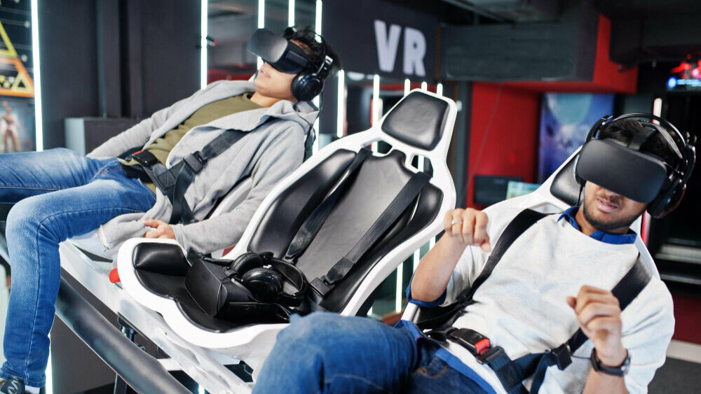 two men using a new technology, virtual driving simulators